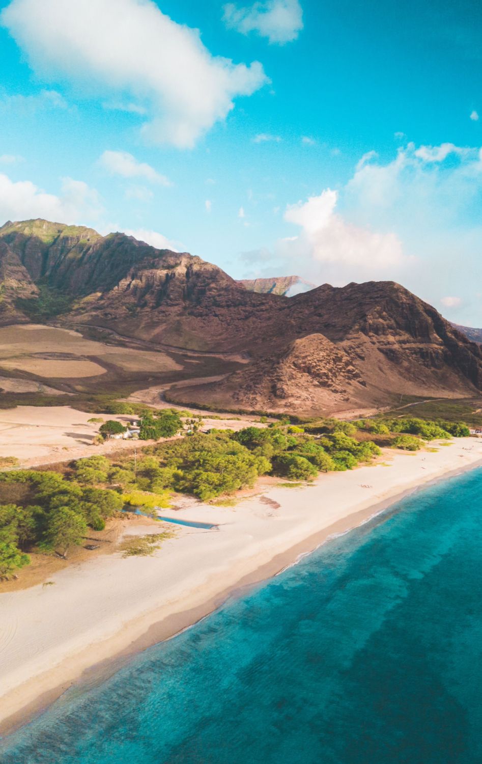 Remote beach and volcanic mountains on the western coast